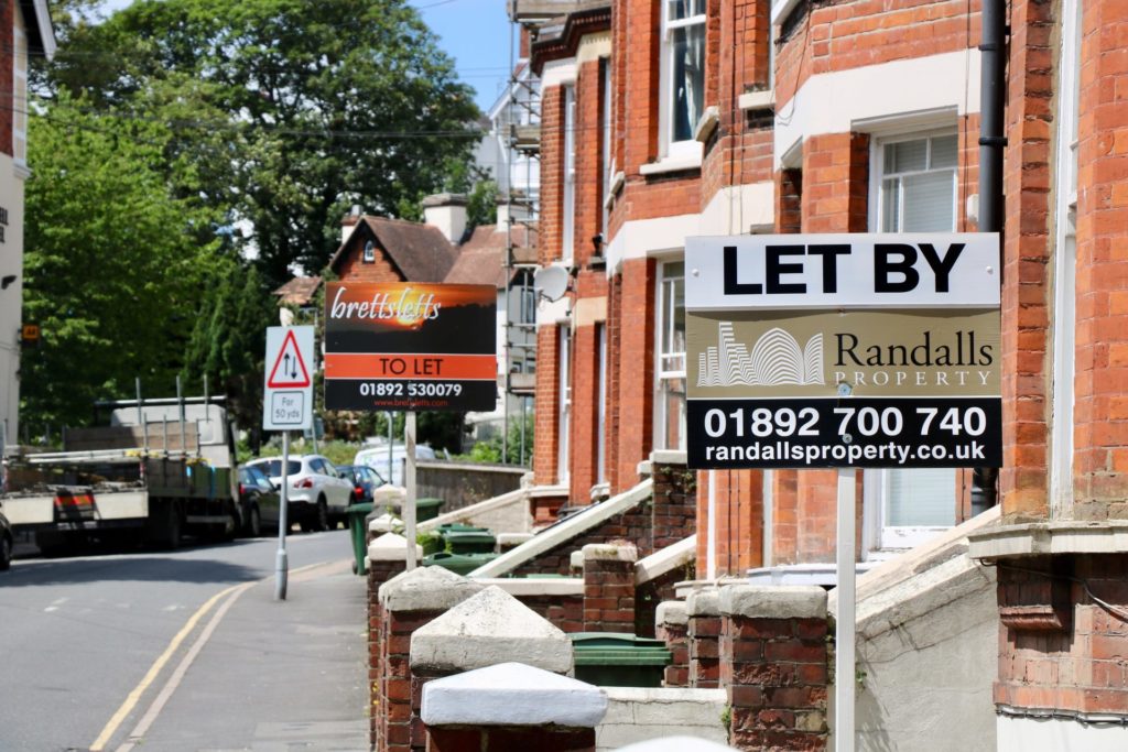 But we live in rented accommodation a picture of a row of brick houses with a sign on 1 of them showing it is for rent