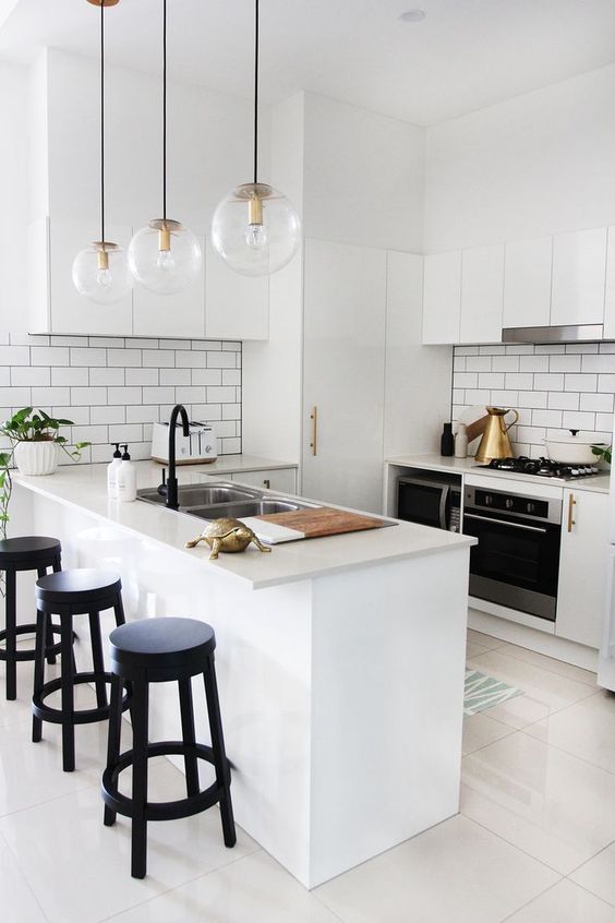 White kitchen room with black accent on island wooden stools