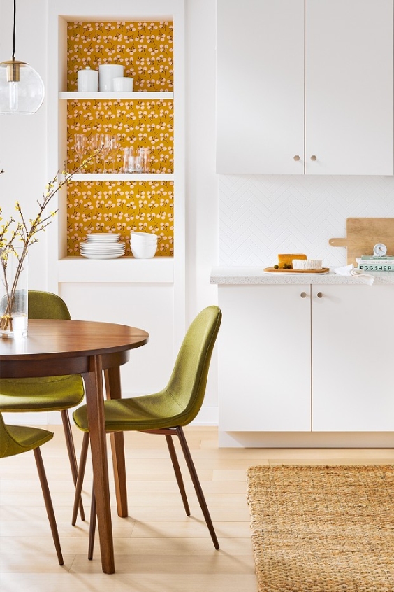 Beautiful mustard colour wallpaper to highlight just one part of white kitchen area