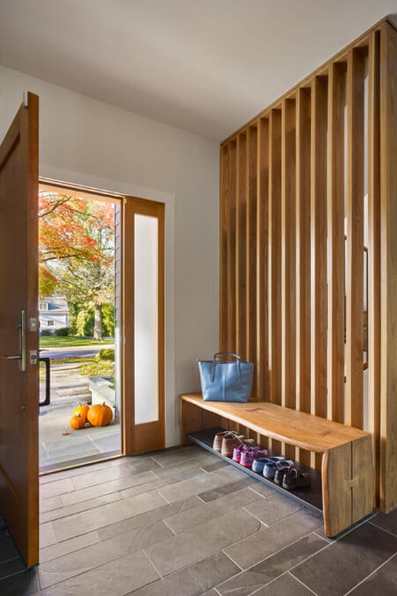 Wooden wall divider in the hallway to separate the entrance from other area of the house